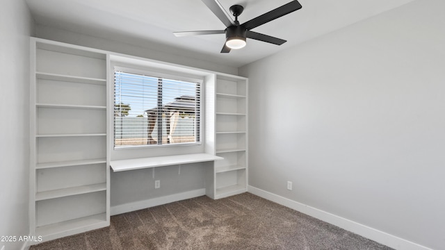 unfurnished bedroom with dark carpet, a ceiling fan, and baseboards