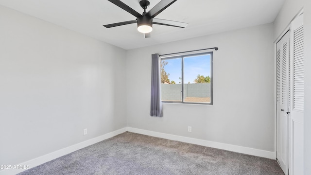 unfurnished bedroom featuring a closet, carpet flooring, a ceiling fan, and baseboards