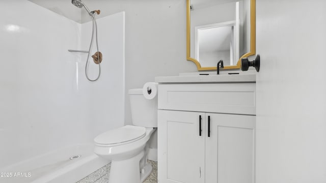 bathroom featuring toilet, walk in shower, and vanity