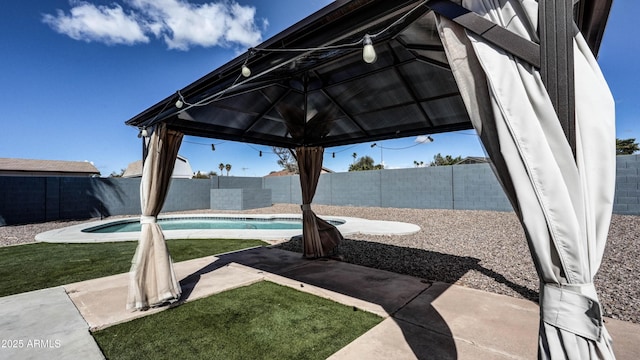 view of patio featuring a gazebo, a fenced backyard, and a fenced in pool