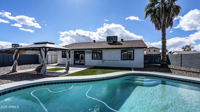 view of pool featuring a fenced in pool, a patio, a gazebo, central AC unit, and a fenced backyard