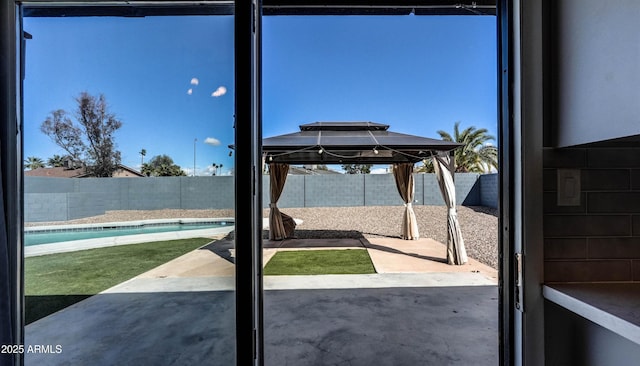 view of patio featuring a fenced in pool, a fenced backyard, and a gazebo