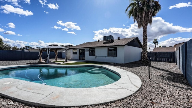 view of swimming pool with a gazebo, central AC unit, a patio, and a fenced backyard