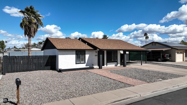 single story home with roof with shingles, fence, driveway, and stucco siding