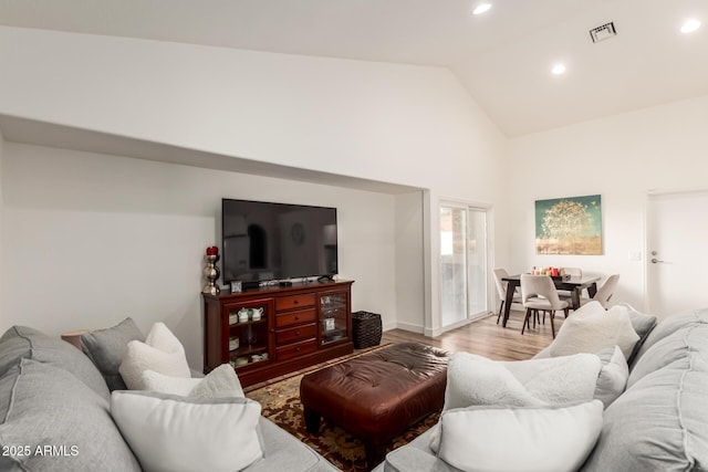 living room with lofted ceiling and light wood-type flooring