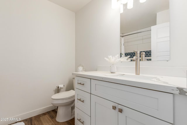 bathroom featuring vanity, toilet, and wood-type flooring