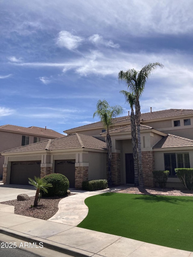 view of front of property featuring a garage and a front yard