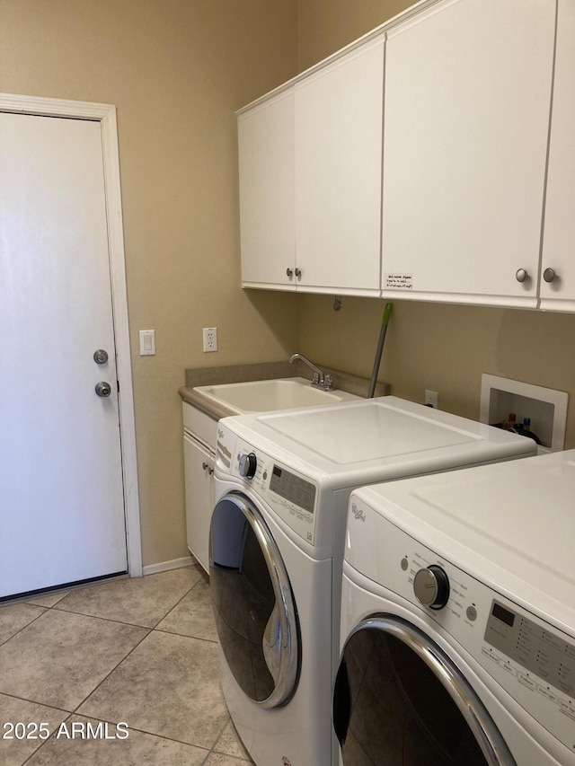 laundry room featuring independent washer and dryer, cabinets, sink, and light tile patterned floors