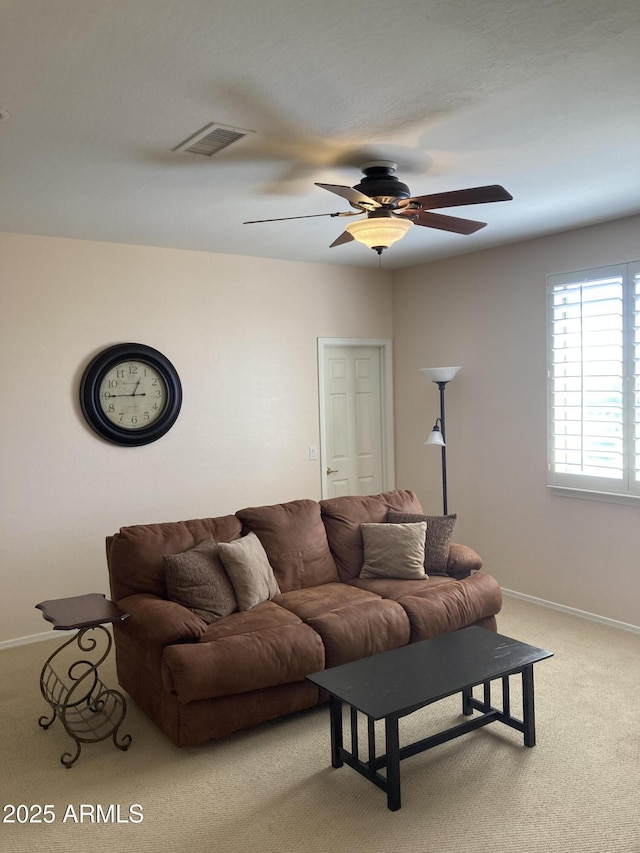 living room featuring light carpet and ceiling fan