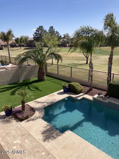 view of pool with a yard