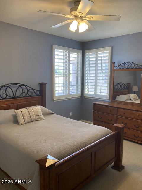 bedroom with ceiling fan and carpet