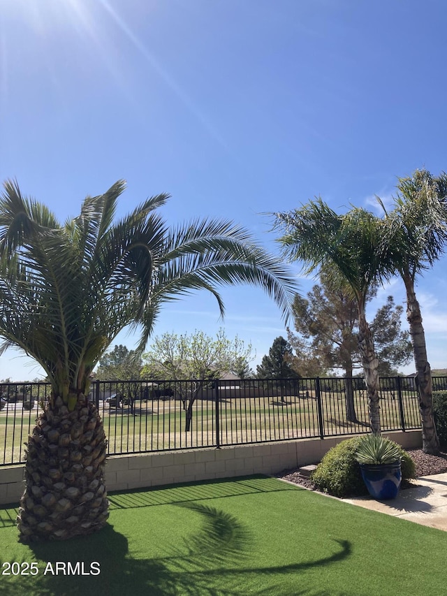 view of gate with a lawn