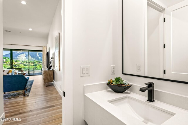 bathroom with vanity and hardwood / wood-style floors