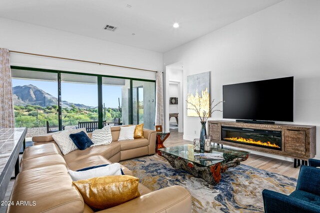 living room featuring light hardwood / wood-style flooring and a mountain view