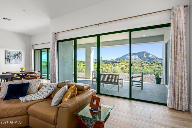 living room with a mountain view and light hardwood / wood-style flooring