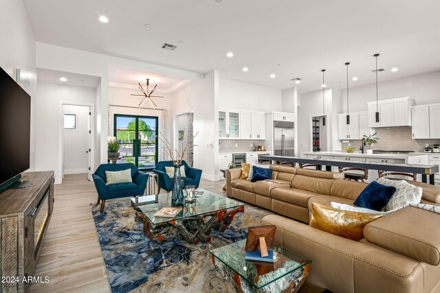 living room featuring beverage cooler and light wood-type flooring