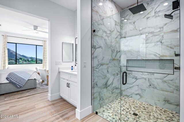 bathroom with ceiling fan, a mountain view, vanity, an enclosed shower, and hardwood / wood-style floors