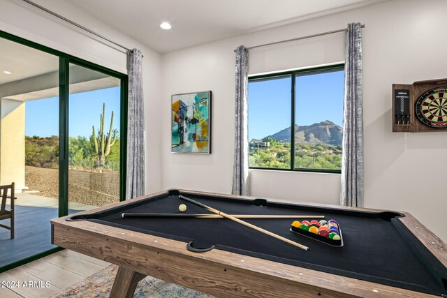 rec room with pool table, light wood-type flooring, and a mountain view