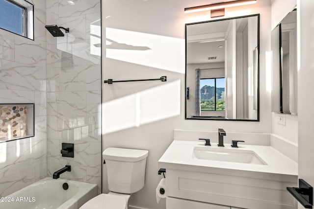 full bathroom with tiled shower / bath combo, vanity, and toilet