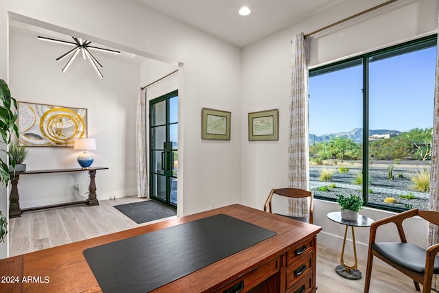 home office with french doors, a mountain view, and light wood-type flooring