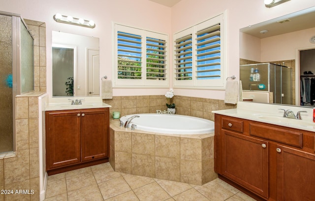 bathroom with tile patterned floors, shower with separate bathtub, and vanity