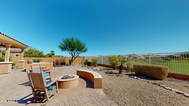 view of patio / terrace featuring an outdoor fire pit