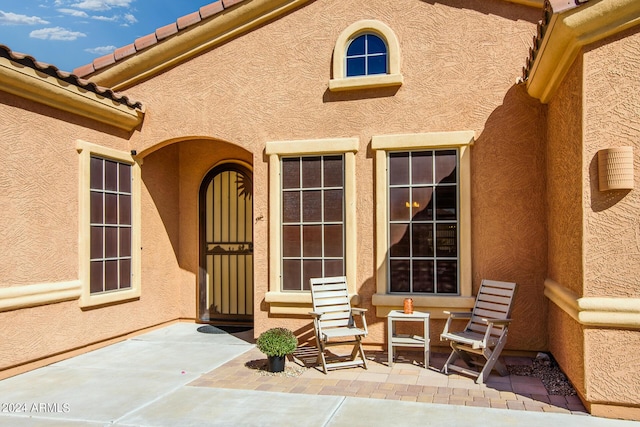 entrance to property with a patio