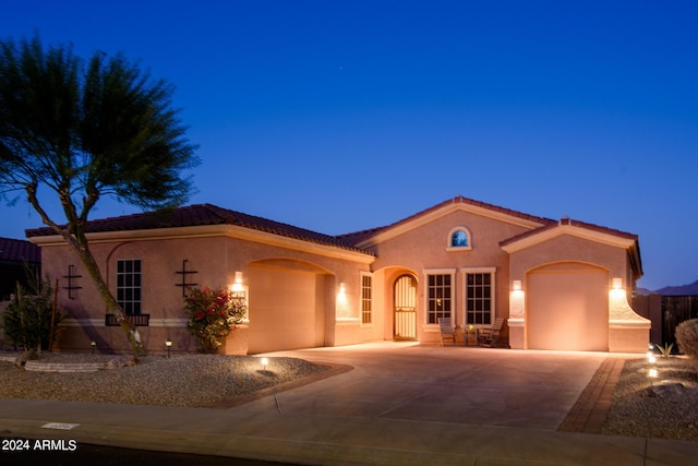 mediterranean / spanish-style home with a garage