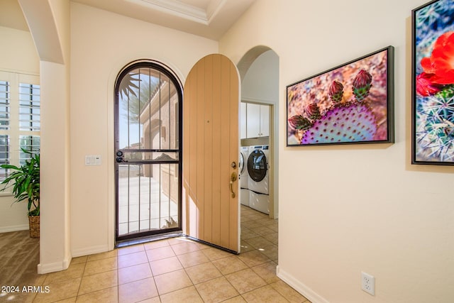 tiled entrance foyer with washing machine and dryer