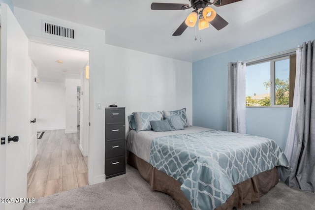 bedroom featuring light carpet and ceiling fan