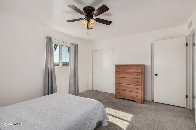 carpeted bedroom with a closet and ceiling fan