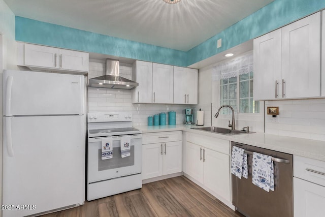 kitchen featuring sink, white appliances, dark wood-type flooring, white cabinets, and wall chimney exhaust hood