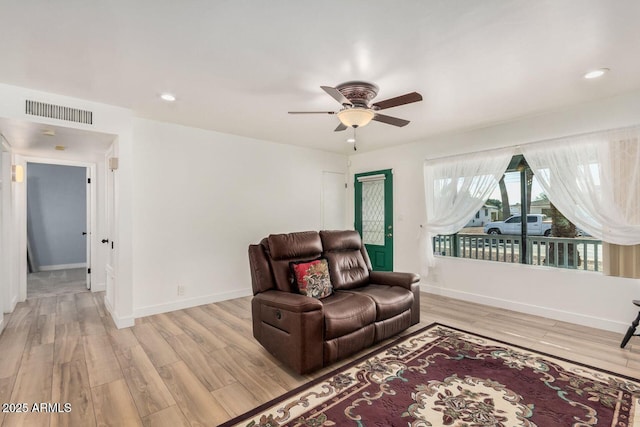 living room featuring ceiling fan and light wood-type flooring