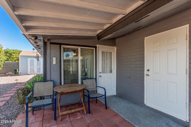 view of patio featuring a storage shed