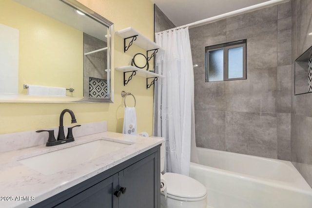 full bathroom with vanity, shower / tub combo with curtain, and toilet