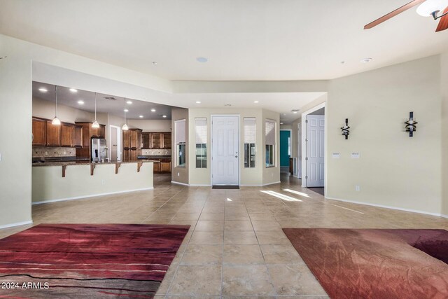 interior space featuring light tile patterned floors, sink, and ceiling fan