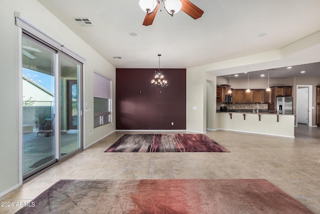 interior space with sink and ceiling fan with notable chandelier