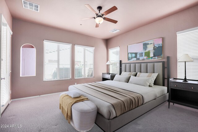 bedroom with ceiling fan and light colored carpet