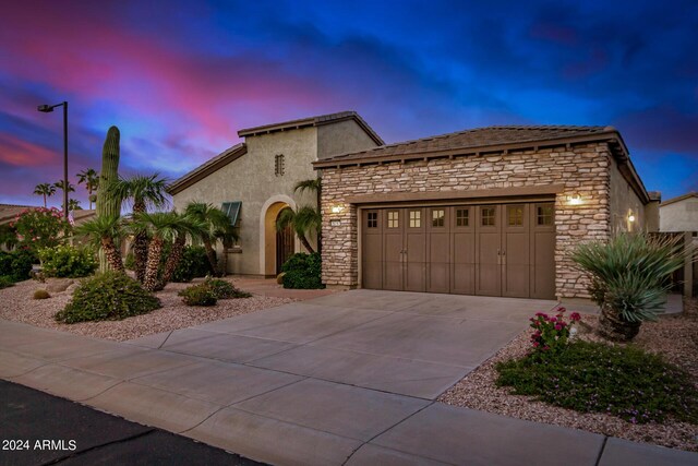 mediterranean / spanish-style home with a garage