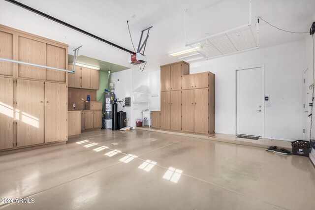 garage featuring gas water heater and a garage door opener