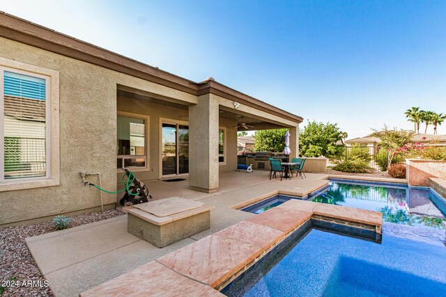 view of pool with an in ground hot tub and a patio area