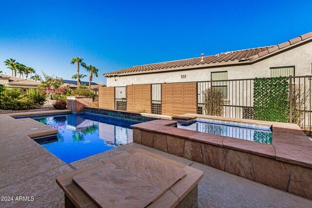 view of swimming pool with a patio area and an in ground hot tub