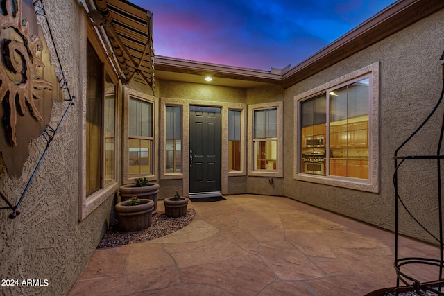 view of patio terrace at dusk