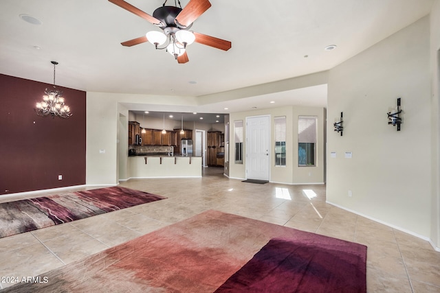 tiled living room featuring ceiling fan with notable chandelier