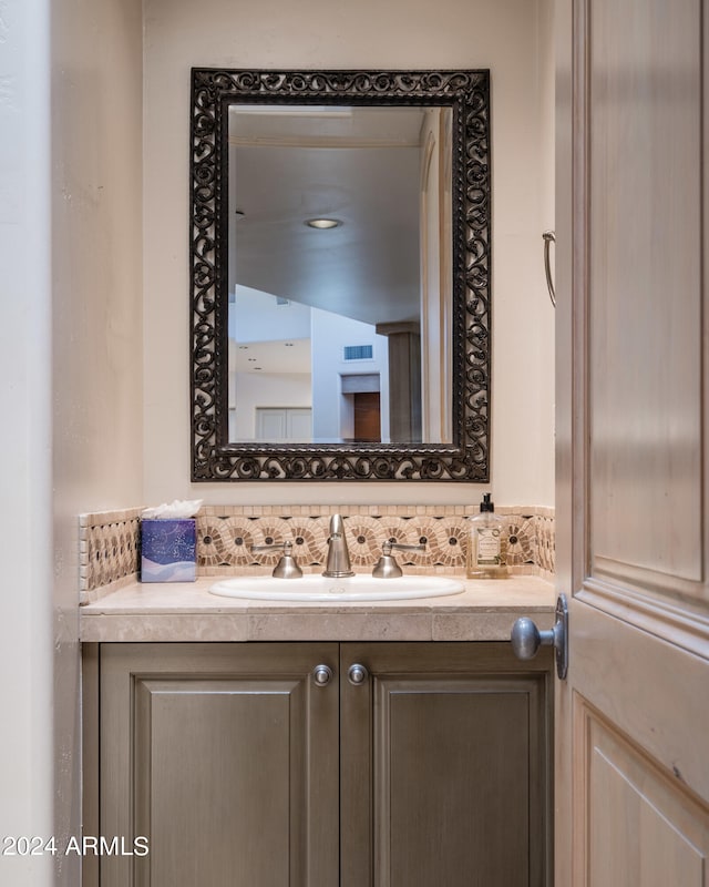 bathroom with vanity and backsplash