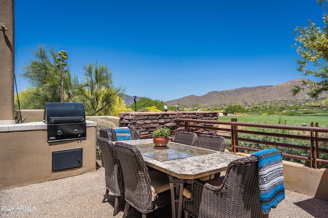 view of patio with a grill and a mountain view