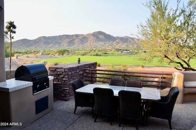 view of patio with a mountain view, a grill, and exterior kitchen