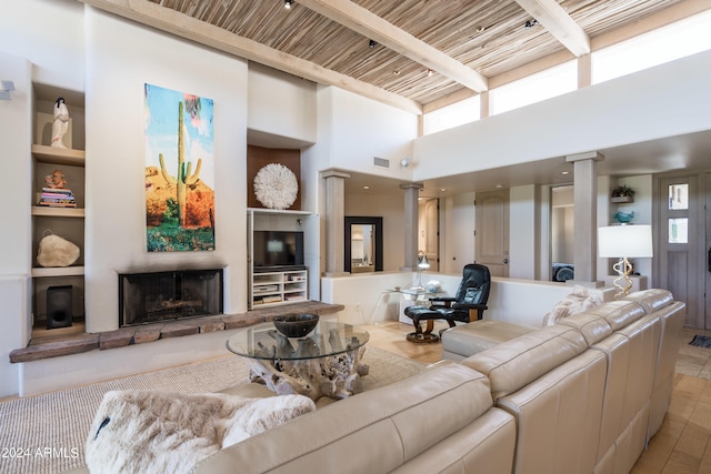 living room with wooden ceiling, a high ceiling, ornate columns, built in features, and beam ceiling