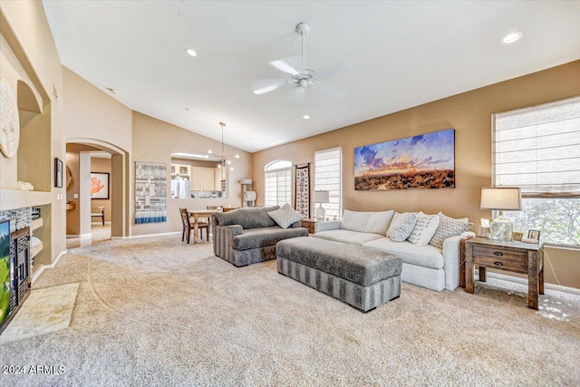 living room featuring lofted ceiling, carpet flooring, plenty of natural light, and ceiling fan