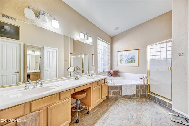 bathroom with vanity and separate shower and tub